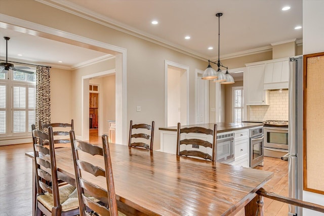 721 Bishops Cir, Evans, GA 30809 - dining space with ceiling fan, ornamental molding, a healthy amount of sunlight, and light wood-type flooring