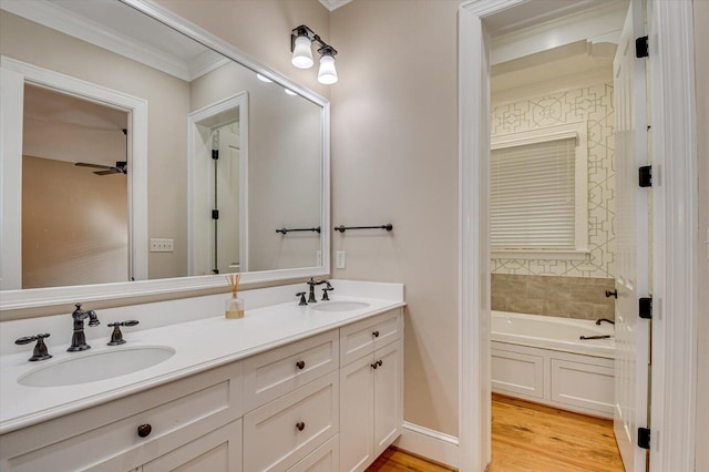 721 Bishops Cir, Evans, GA 30809 - bathroom featuring ceiling fan, vanity, wood-type flooring, ornamental molding, and a tub