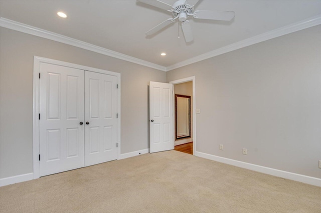 721 Bishops Cir, Evans, GA 30809 - unfurnished bedroom featuring crown molding, light colored carpet, ceiling fan, and a closet