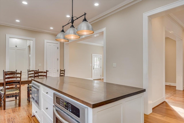 721 Bishops Cir, Evans, GA 30809 - kitchen featuring white cabinetry, hanging light fixtures, stainless steel appliances, and light wood-type flooring