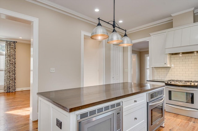 721 Bishops Cir, Evans, GA 30809 - kitchen featuring white cabinetry, light hardwood / wood-style flooring, ornamental molding, pendant lighting, and stainless steel appliances