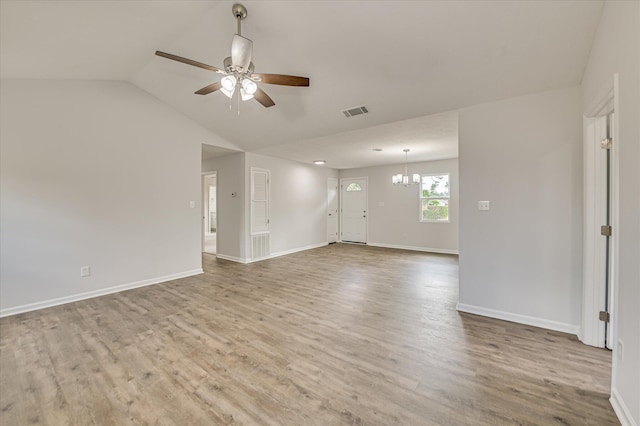 unfurnished living room featuring visible vents, ceiling fan with notable chandelier, wood finished floors, and lofted ceiling
