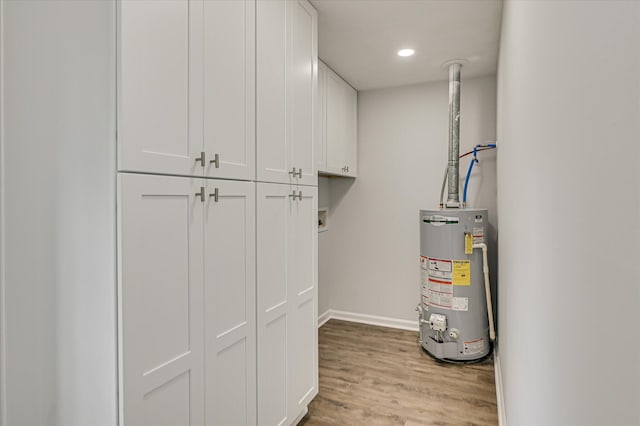 utility room featuring gas water heater