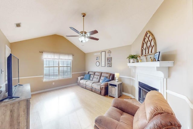 living room featuring ceiling fan and lofted ceiling