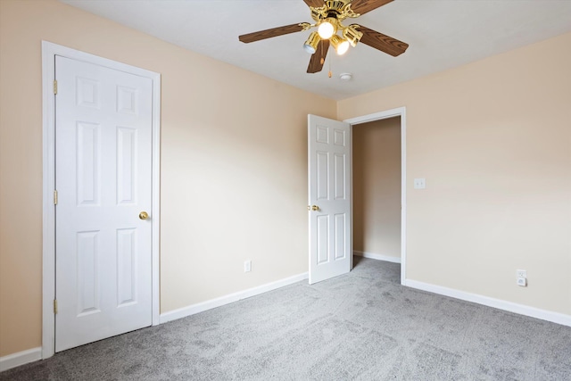 spare room featuring ceiling fan and light carpet