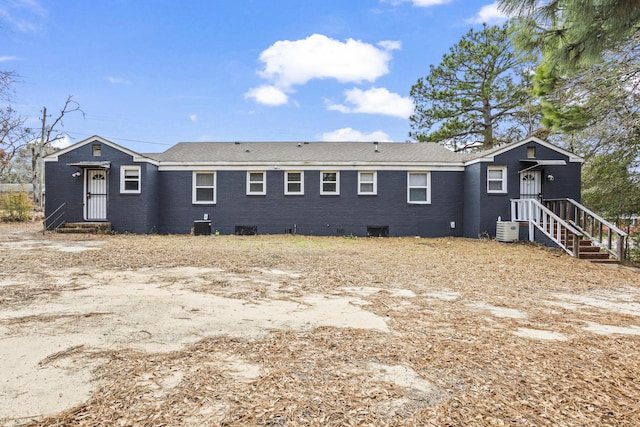 rear view of property featuring central air condition unit