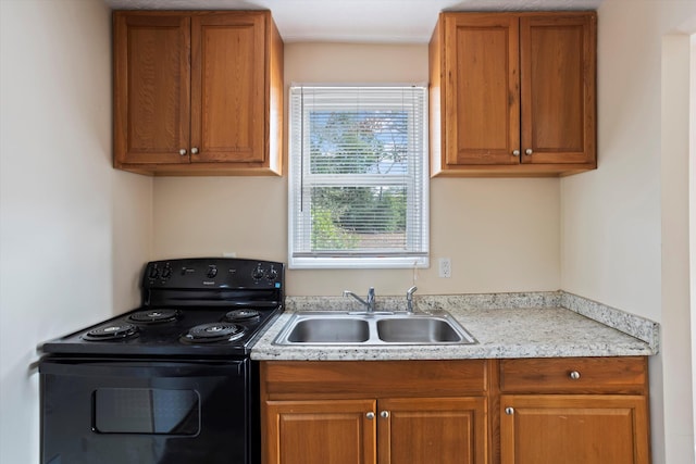 kitchen featuring black range with electric stovetop and sink