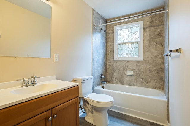 full bathroom with hardwood / wood-style flooring, vanity, toilet, and tiled shower / bath combo