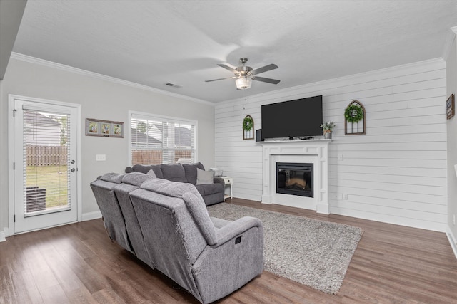 604 Garland Trl, Harlem, GA 30814 - living room featuring wood finished floors, a ceiling fan, visible vents, and crown molding
