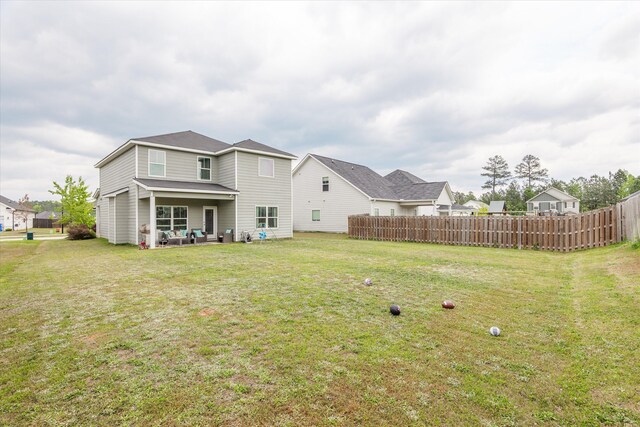 604 Garland Trl, Harlem, GA 30814 - rear view of property with fence, a yard, and an outdoor living space