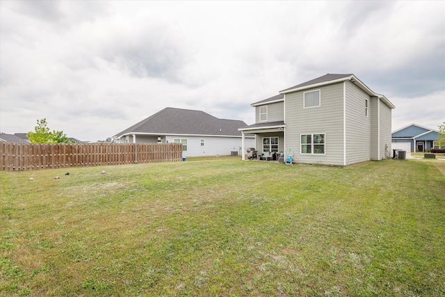 604 Garland Trl, Harlem, GA 30814 - back of house with central air condition unit, fence, and a lawn