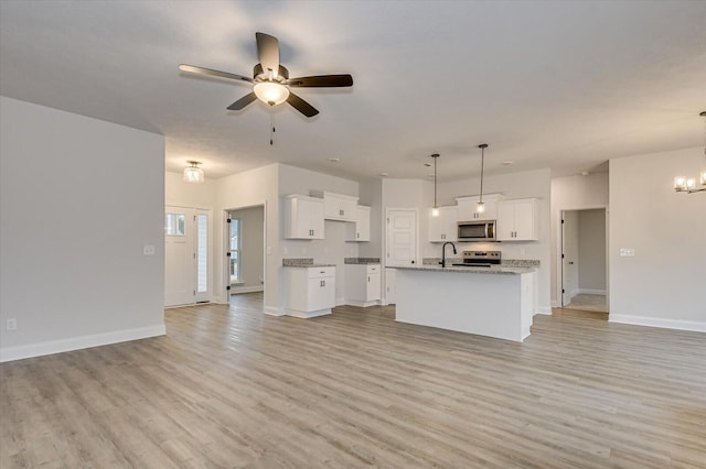 unfurnished living room with ceiling fan with notable chandelier, sink, and light hardwood / wood-style flooring