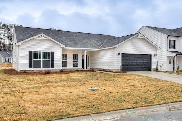 view of front of home featuring a garage and a front lawn