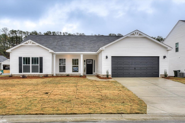 single story home with a front lawn, central AC unit, and a garage