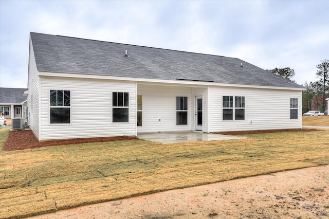 back of property featuring a patio, central AC, and a lawn