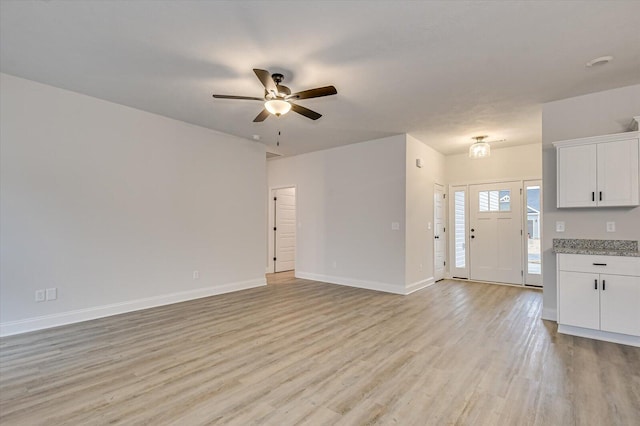 unfurnished living room with ceiling fan and light wood-type flooring