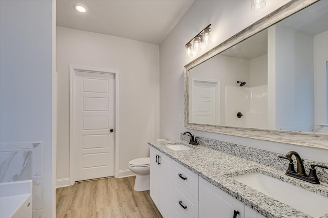 full bathroom with plus walk in shower, hardwood / wood-style floors, vanity, and toilet