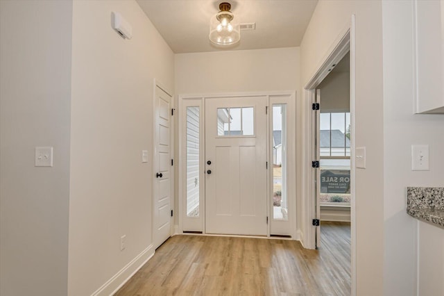 foyer entrance with light hardwood / wood-style floors