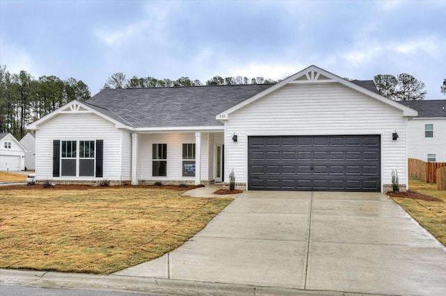 ranch-style home with a garage and a front yard