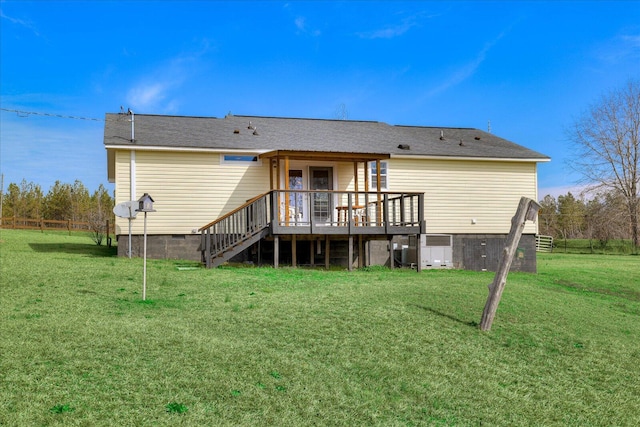 rear view of property with a lawn, crawl space, fence, a deck, and stairs