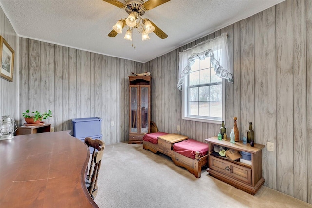 bedroom featuring a ceiling fan, carpet flooring, and a textured ceiling