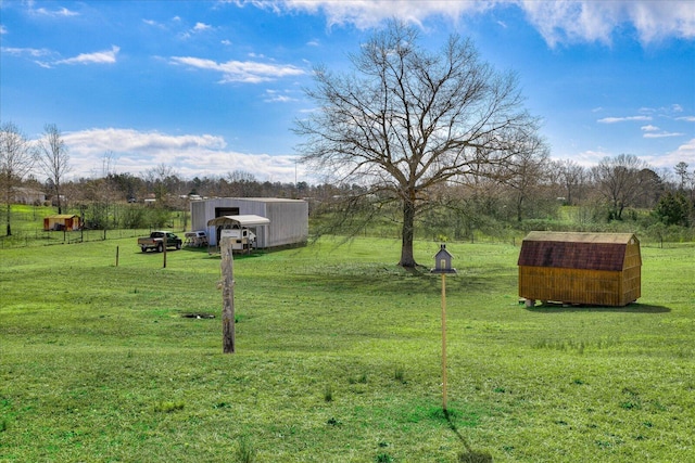 view of yard featuring an outbuilding and a rural view