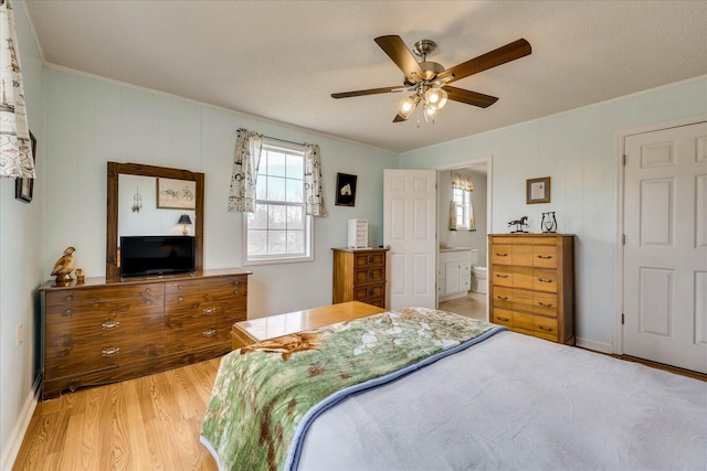 bedroom featuring light wood-style floors, ceiling fan, and baseboards