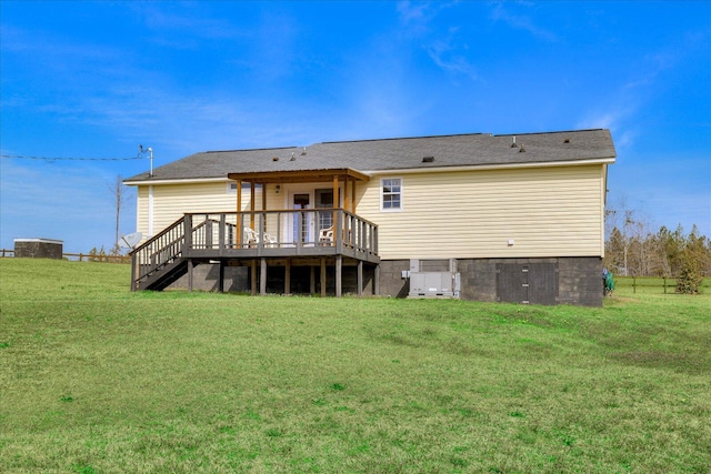 back of property featuring stairway, a lawn, and a wooden deck