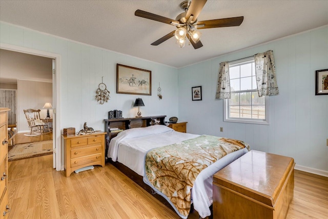 bedroom with a ceiling fan and light wood-style floors