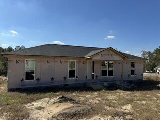 rear view of property featuring a patio area