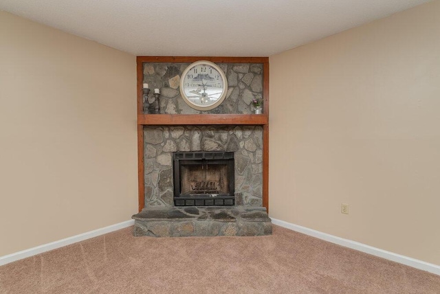 unfurnished living room with carpet and a fireplace