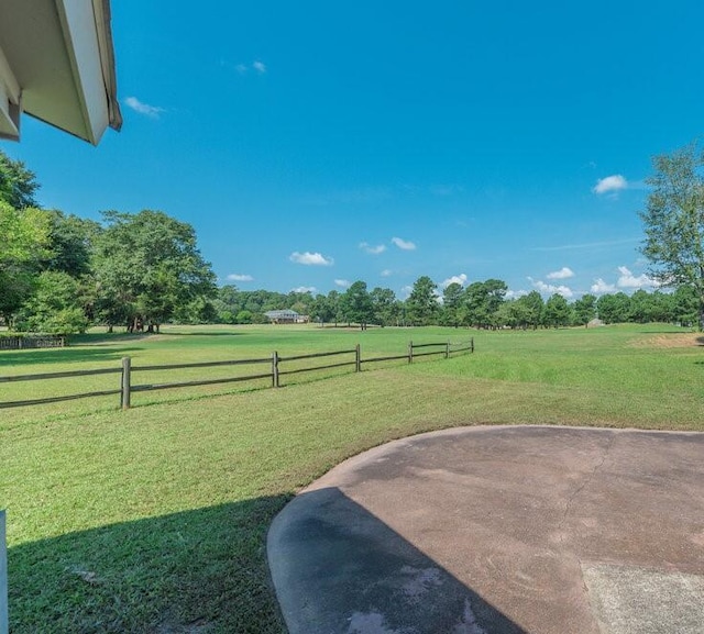 view of yard with a rural view and a patio