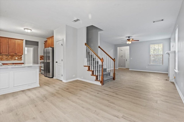 kitchen with ceiling fan, stainless steel fridge, and light wood-type flooring