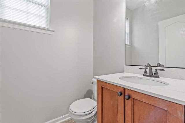 bathroom with tile patterned flooring, vanity, and toilet