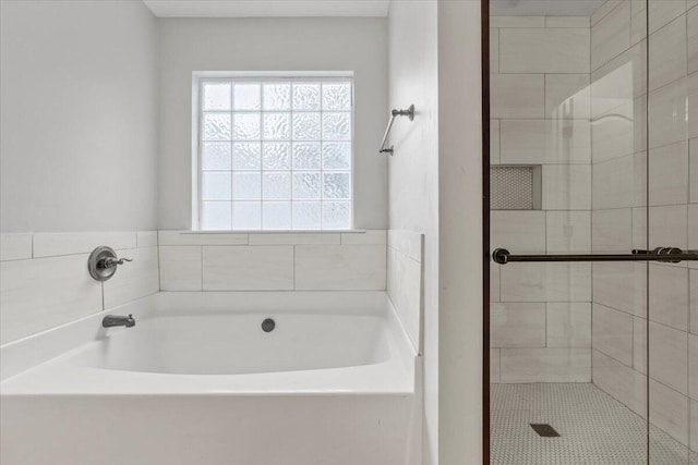 bathroom with shower with separate bathtub