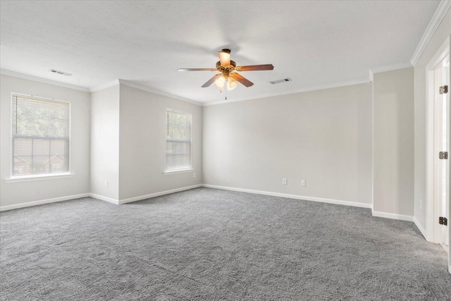 empty room with carpet, ceiling fan, a healthy amount of sunlight, and crown molding