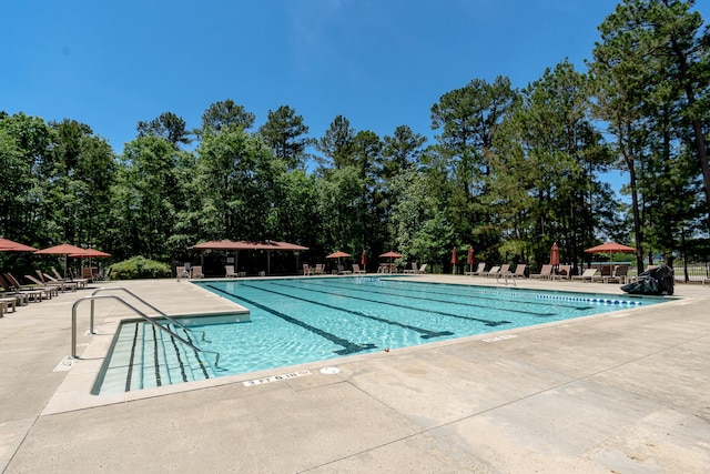 910 Ellis Ln, Evans, GA 30809 - community pool featuring a patio and view of scattered trees