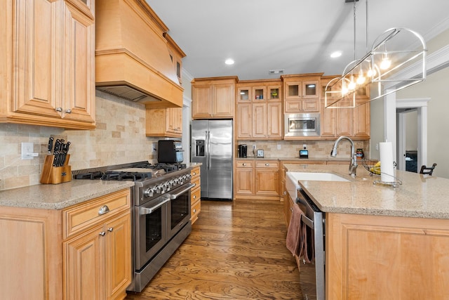910 Ellis Ln, Evans, GA 30809 - kitchen with stainless steel appliances, premium range hood, a sink, wood finished floors, and decorative backsplash