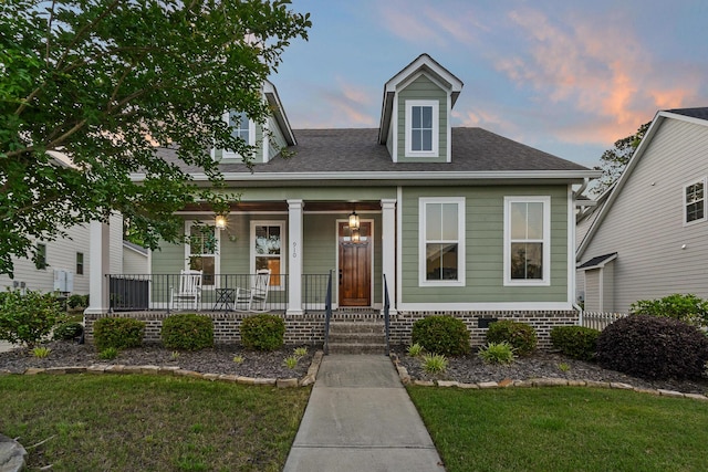 910 Ellis Ln, Evans, GA 30809 - view of front facade featuring a porch, a shingled roof, and a lawn