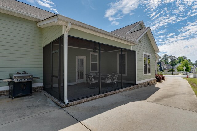 910 Ellis Ln, Evans, GA 30809 - view of home's exterior featuring a sunroom, a patio, ceiling fan, and a shingled roof