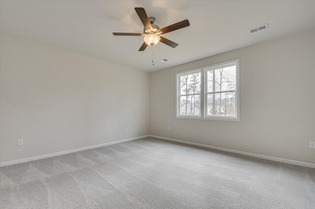 spare room featuring ceiling fan and light carpet