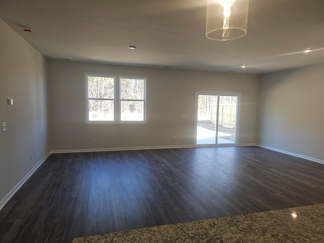 empty room with dark hardwood / wood-style floors