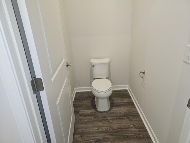 bathroom featuring wood-type flooring and toilet