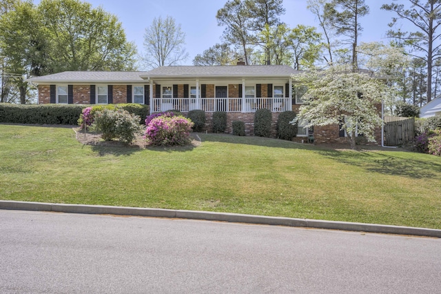 621 Cambridge Rd, Augusta, GA 30909 - ranch-style house featuring a porch, a chimney, brick siding, and a front yard