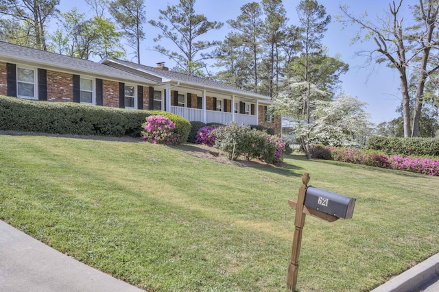 621 Cambridge Rd, Augusta, GA 30909 - single story home featuring brick siding, a front yard, covered porch, and a chimney