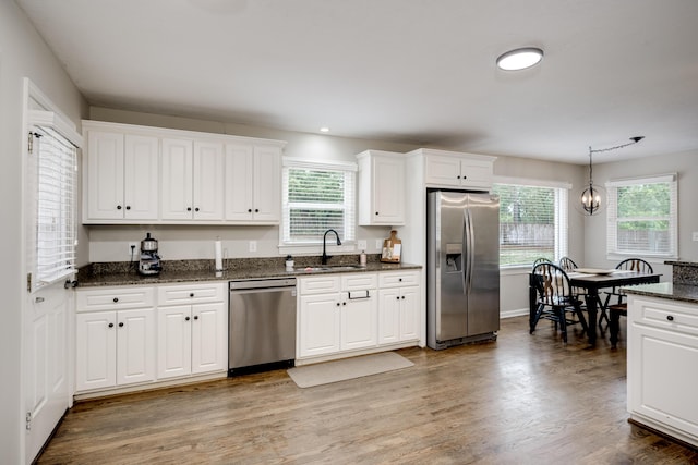 621 Cambridge Rd, Augusta, GA 30909 - kitchen featuring appliances with stainless steel finishes, white cabinets, plenty of natural light, wood finished floors, and recessed lighting
