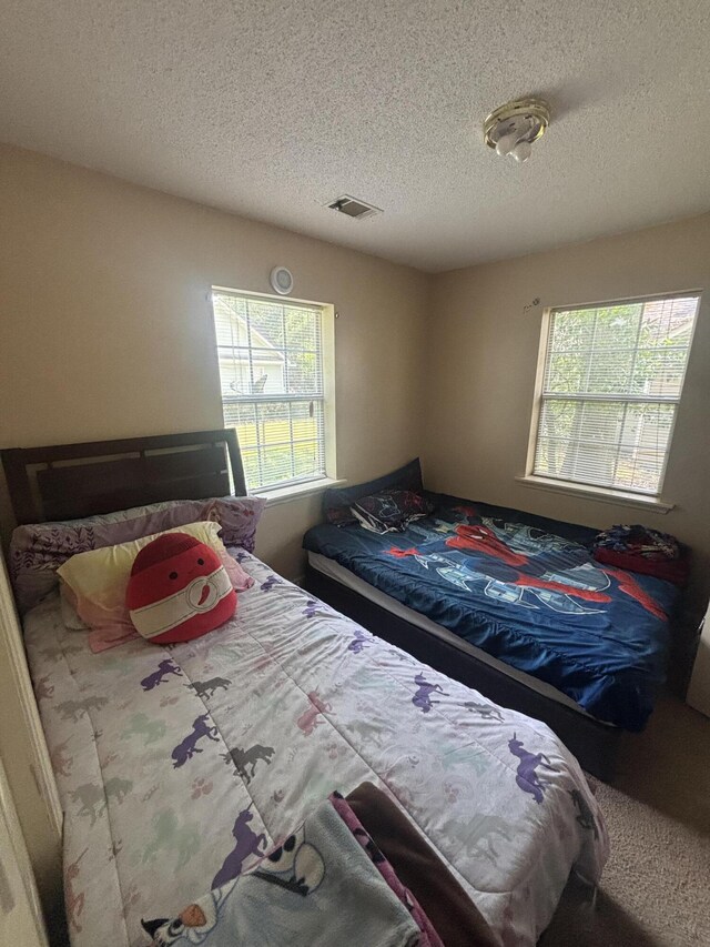 1405 E Thorpe Ln, Aiken, SC 29801 - bedroom featuring a textured ceiling and carpet flooring