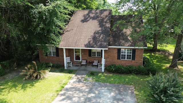 1405 E Thorpe Ln, Aiken, SC 29801 - cape cod house featuring a front lawn, brick siding, roof with shingles, and a porch