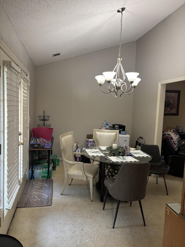 1405 E Thorpe Ln, Aiken, SC 29801 - carpeted dining room with a chandelier, healthy amount of natural light, a textured ceiling, and vaulted ceiling