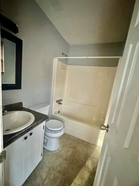 full bathroom featuring toilet, tile patterned flooring, washtub / shower combination, and vanity